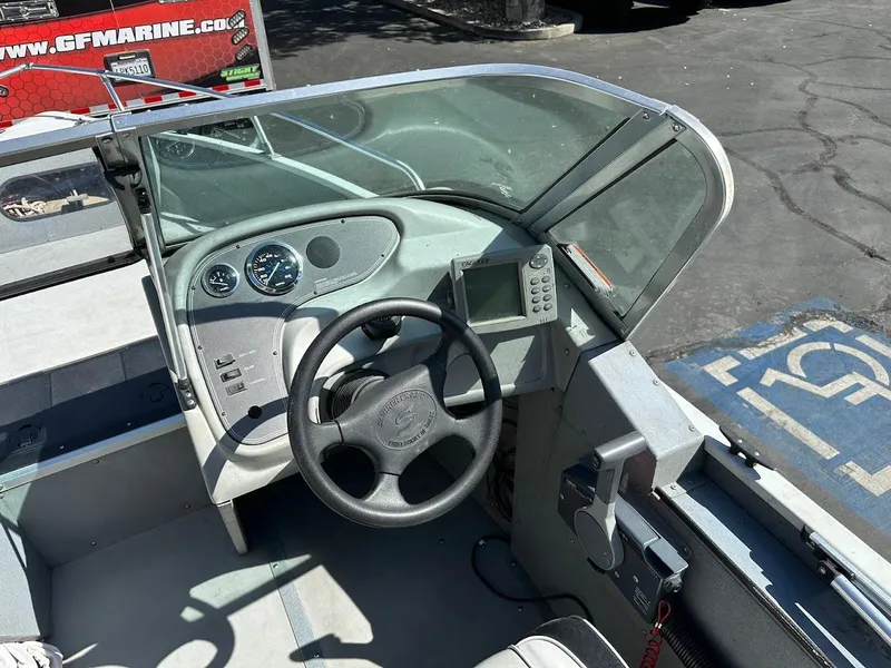 Slide: The Image of 2001 Smoker Craft 160 SP boat dashboard with steering wheel and gauges. - 15