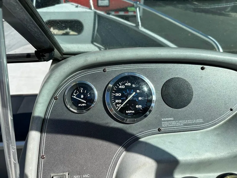 Slide: The Image of Dashboard of a 2001 Smoker Craft 160 SP boat showing fuel and speed gauges. - 18