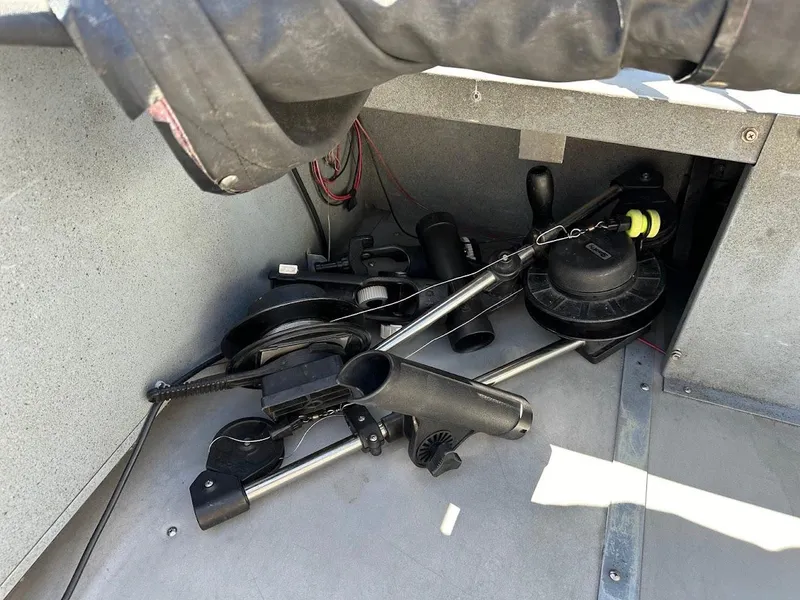 Slide: The Image of Boat interior showing fishing equipment storage on a 2001 Smoker Craft 160 SP. - 19