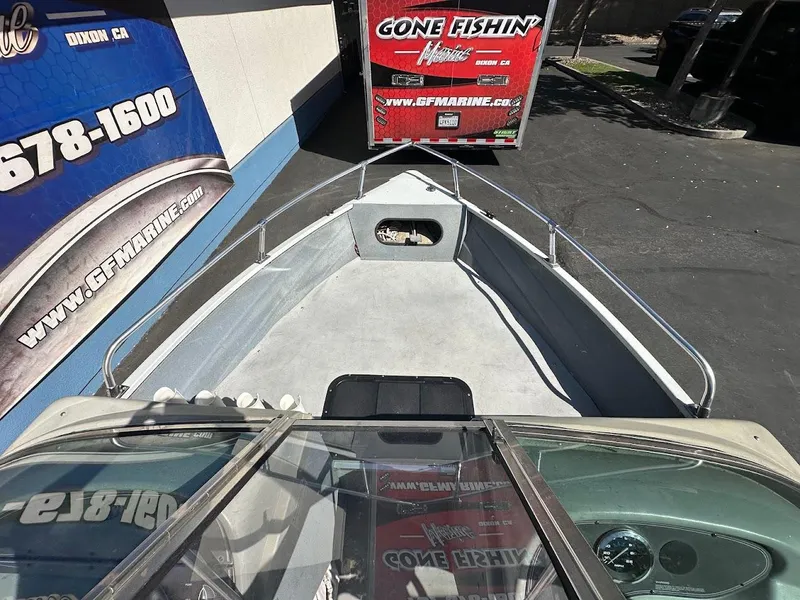 Slide: The Image of 2001 Smoker Craft 160 SP boat parked near GF Marine trailer. - 23