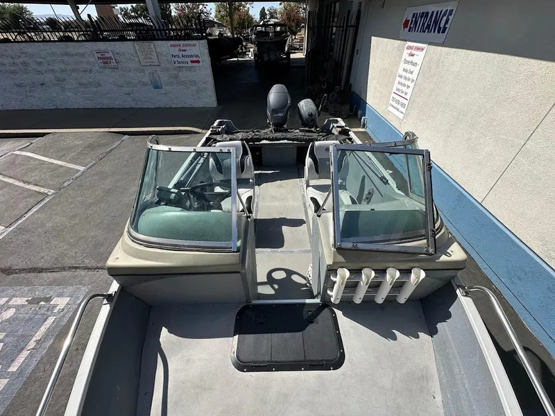 Slide: The Image of 2001 Smoker Craft 160 SP boat with dual windshields, parked outdoors. - 25