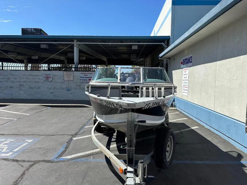 Slide: The Image of 2001 Smoker Craft 160 SP boat on trailer in parking lot. - 3