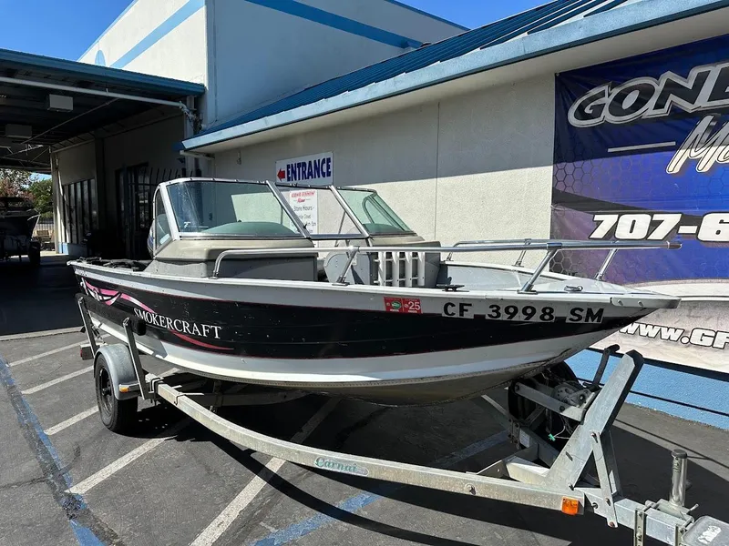 Slide: The Image of 2001 Smoker Craft 160 SP boat on trailer outside dealership. - 5