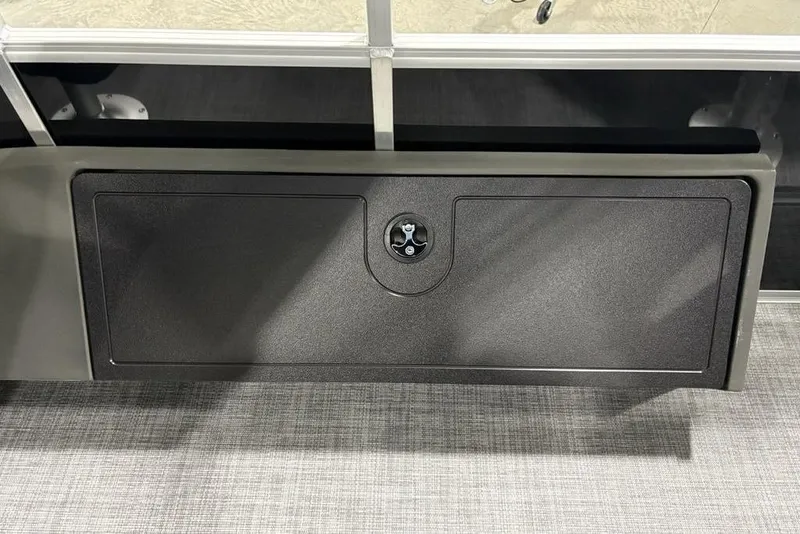 Slide: The Image of 2026 Sun Tracker SportFish™ 22 DLX storage compartment with secure latch. - 13