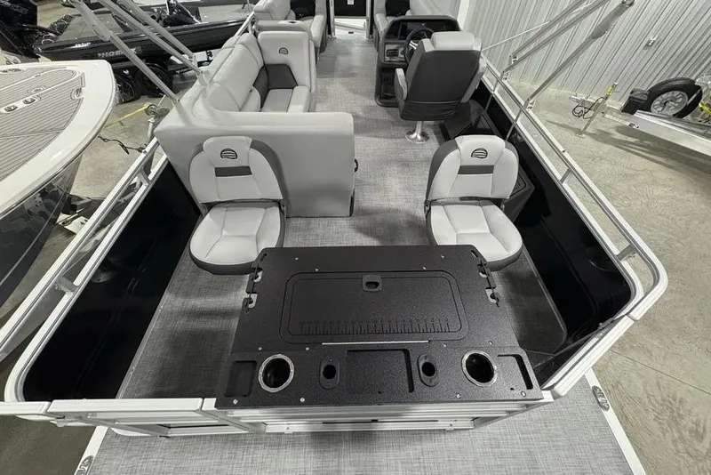 Slide: The Image of 2026 Sun Tracker SportFish™ 22 DLX pontoon boat interior with seating and fishing station. - 21