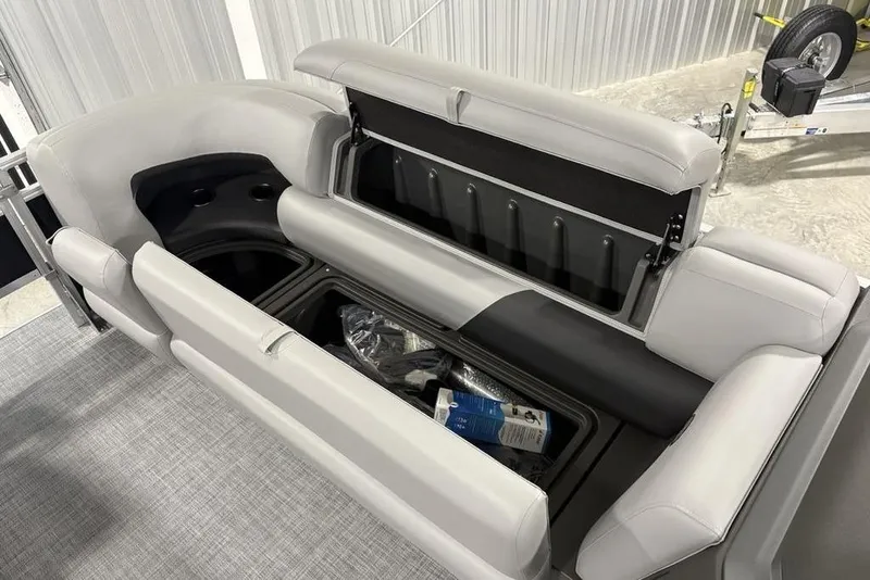 Slide: The Image of 2026 Sun Tracker SportFish™ 22 DLX boat interior with storage compartments and seating. - 23