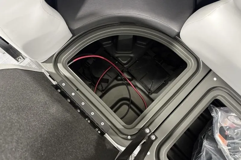 Slide: The Image of Storage compartment of 2026 Sun Tracker SportFish™ 22 DLX boat, featuring wiring and seating. - 24