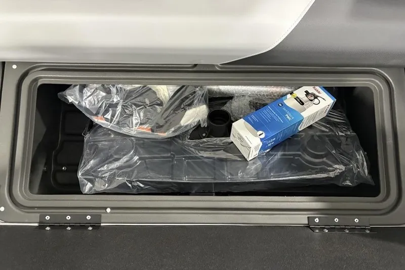 Slide: The Image of Storage compartment of 2026 Sun Tracker SportFish™ 22 DLX with packaged items inside. - 30