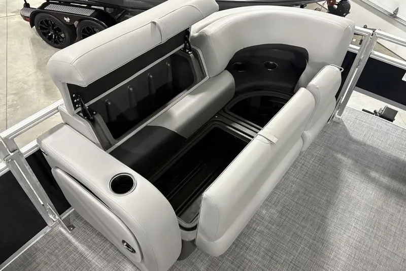 Slide: The Image of 2026 Sun Tracker SportFish™ 22 DLX boat interior with storage and cup holders. - 31
