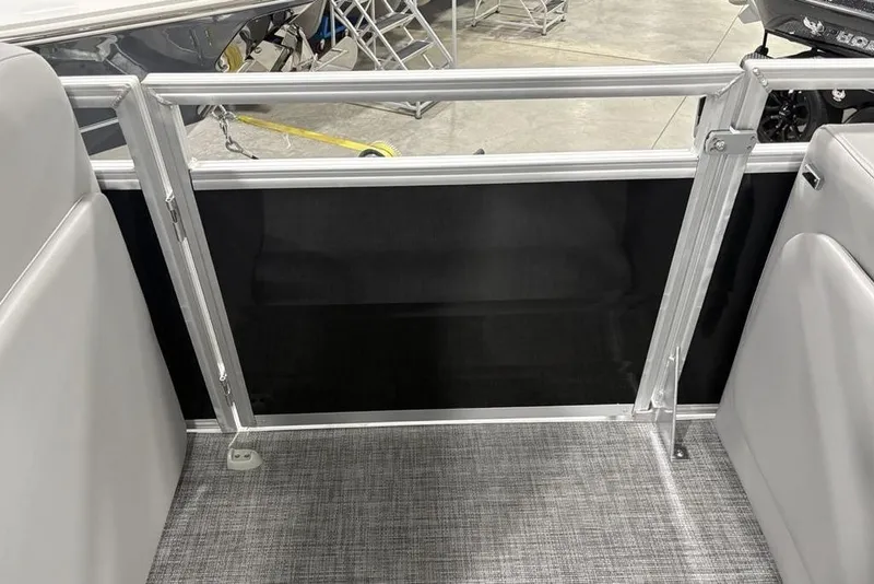 Slide: The Image of 2026 Sun Tracker SportFish™ 22 DLX interior with gray seating and metal railing. - 34