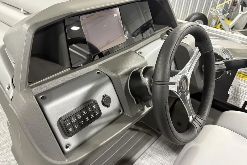 Slide: The Image of 2026 Sun Tracker SportFish™ 22 DLX dashboard with steering wheel and control panel. - 40