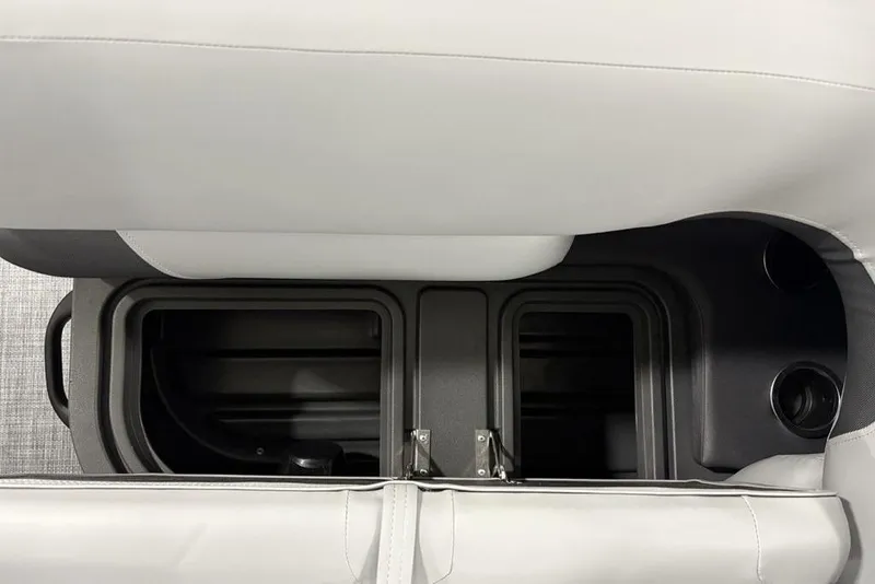 Slide: The Image of 2026 Sun Tracker SportFish™ 22 DLX storage compartment with cup holders and sleek design. - 8