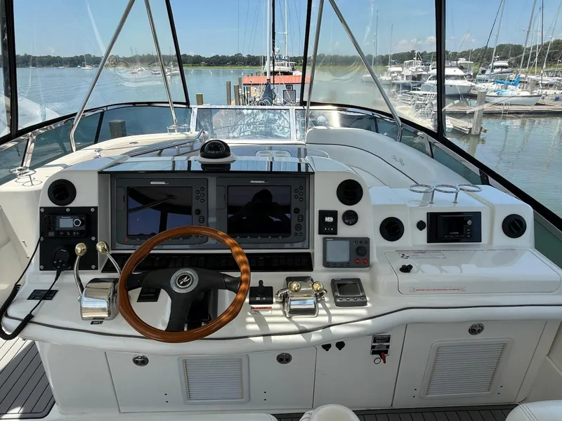Slide: The Image of 2007 Sea Ray 52 Sedan Bridge helm with advanced navigation systems and marina view. - 14