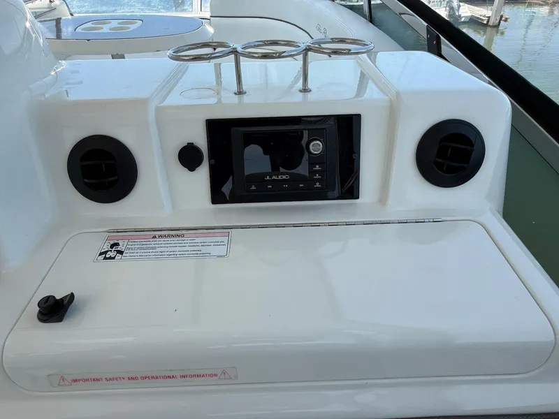 Slide: The Image of 2007 Sea Ray 52 Sedan Bridge audio system with JL Audio controls and cup holders. - 16