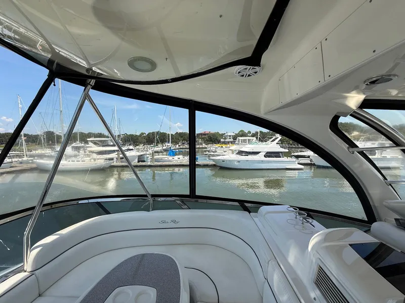 Slide: The Image of 2007 Sea Ray 52 Sedan Bridge interior with marina view through large windows. - 17