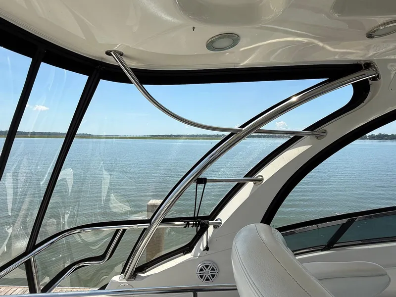 Slide: The Image of Interior view of 2007 Sea Ray 52 Sedan Bridge with water scenery through windows. - 18