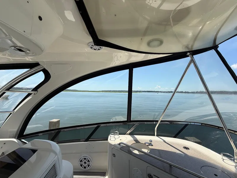 Slide: The Image of Interior view of 2007 Sea Ray 52 Sedan Bridge yacht overlooking calm waters. - 20