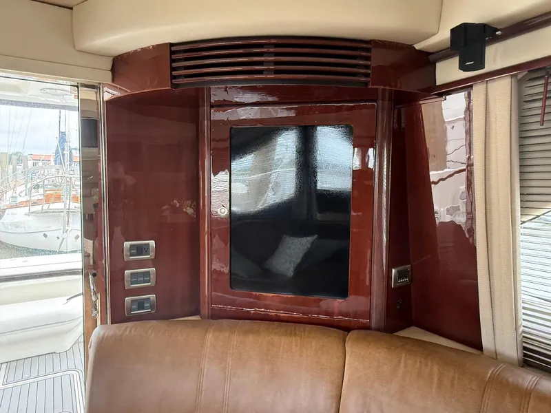 Slide: The Image of Interior of 2007 Sea Ray 52 Sedan Bridge yacht with polished wood paneling. - 28