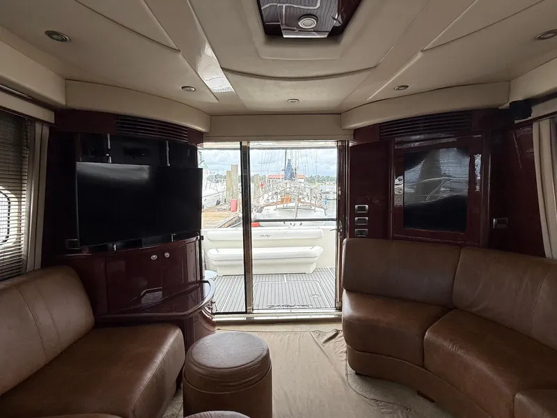 Slide: The Image of Luxurious interior of 2007 Sea Ray 52 Sedan Bridge yacht with leather seating and large TV. - 29