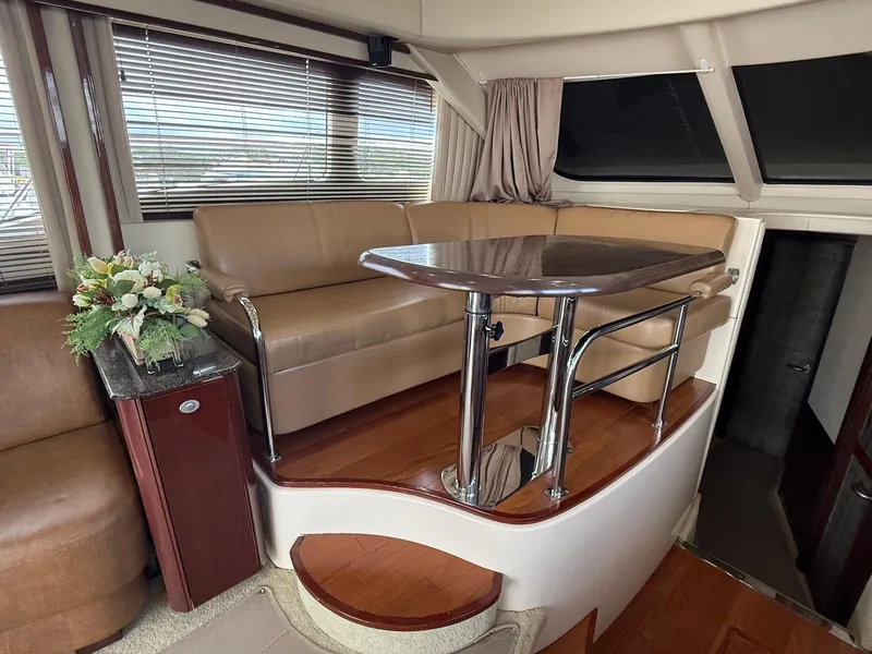 Slide: The Image of Luxurious interior of 2007 Sea Ray 52 Sedan Bridge with leather seating and elegant table. - 30