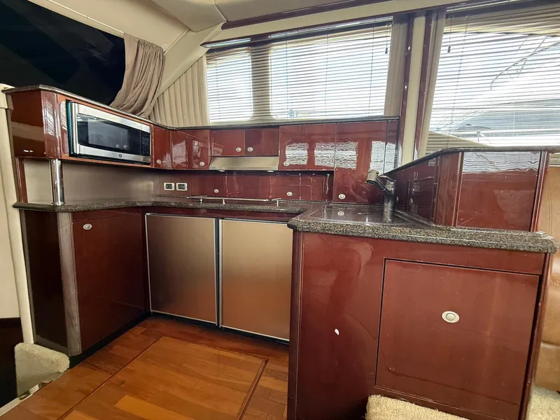 Slide: The Image of Luxurious kitchen interior of 2007 Sea Ray 52 Sedan Bridge yacht with modern appliances. - 32