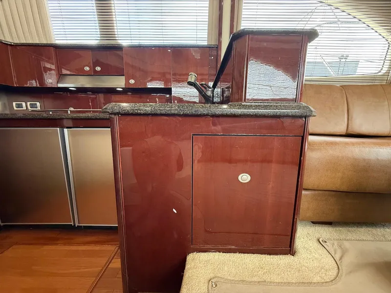 Slide: The Image of Luxurious interior of 2007 Sea Ray 52 Sedan Bridge yacht with polished wood cabinetry. - 33