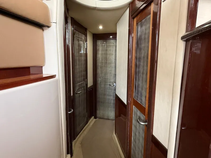 Slide: The Image of Interior hallway of a 2007 Sea Ray 52 Sedan Bridge yacht, featuring wooden doors and beige accents. - 34
