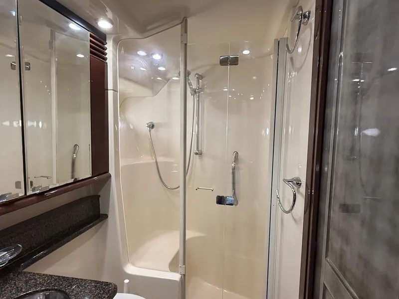 Slide: The Image of Luxurious bathroom in 2007 Sea Ray 52 Sedan Bridge yacht with glass shower enclosure. - 38