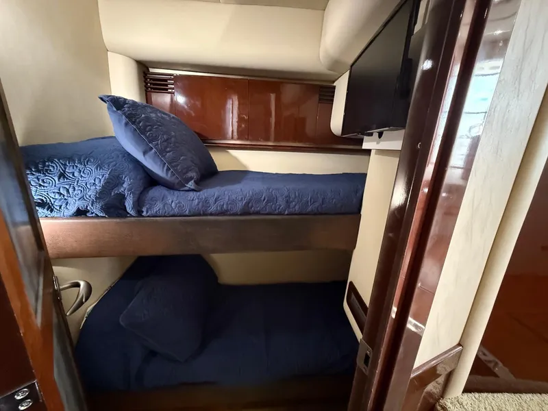 Slide: The Image of Bunk beds with blue bedding in 2007 Sea Ray 52 Sedan Bridge yacht cabin. - 40