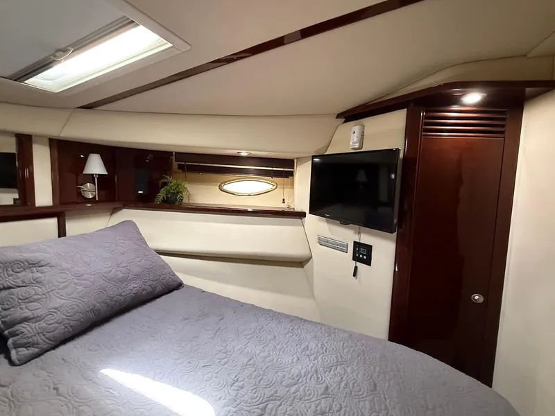 Slide: The Image of Luxurious cabin interior of 2007 Sea Ray 52 Sedan Bridge yacht with TV and elegant bedding. - 45