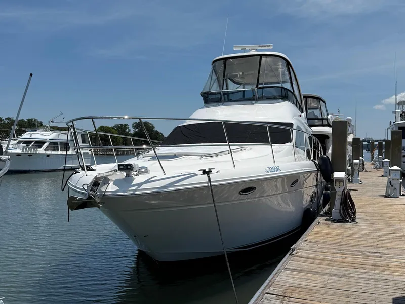 Slide: The Image of 2007 Sea Ray 52 Sedan Bridge yacht docked at marina under clear blue sky. - 7