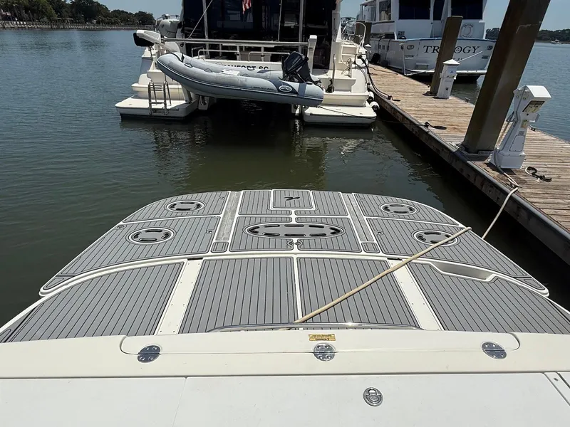 Slide: The Image of 2007 Sea Ray 52 Sedan Bridge yacht docked with inflatable boat on water. - 8