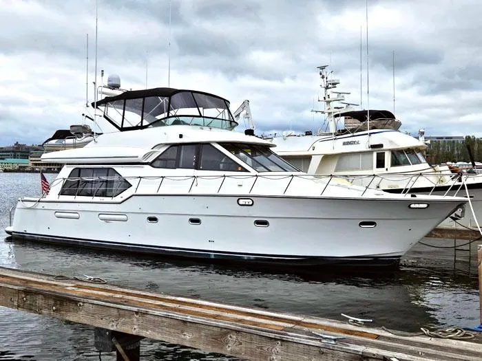 The Image of 2000 Bayliner 5288 Pilot House Motoryacht docked at marina under cloudy sky. - 0