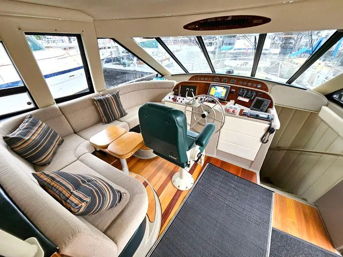 Slide: The Image of Luxurious interior of 2000 Bayliner 5288 Pilot House Motoryacht with helm and seating area. - 12