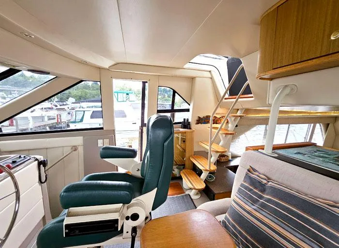Slide: The Image of Interior of 2000 Bayliner 5288 Pilot House Motoryacht with seating and stairs. - 14