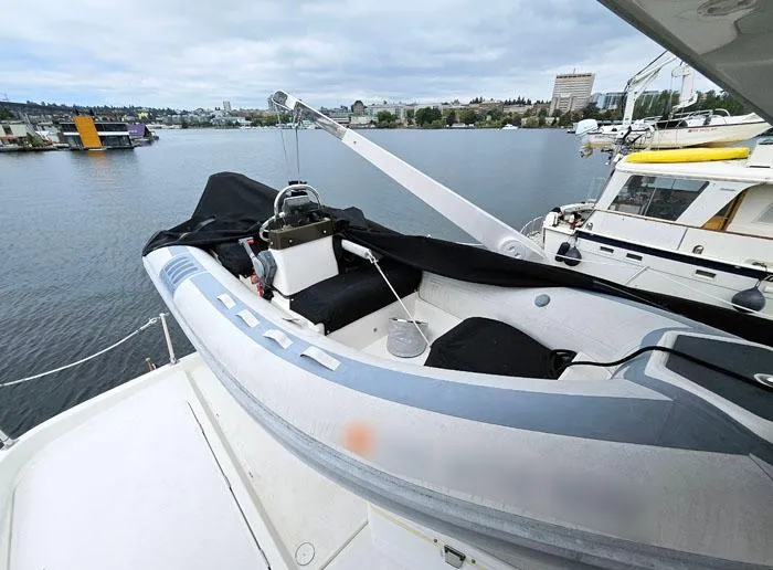 Slide: The Image of 2000 Bayliner 5288 Pilot House Motoryacht with dinghy on deck, docked at marina. - 17