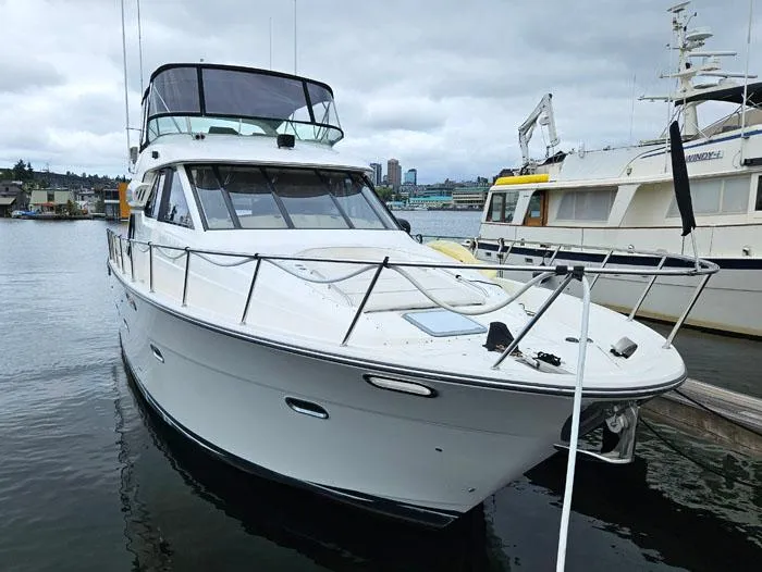 Slide: The Image of 2000 Bayliner 5288 Pilot House Motoryacht docked in a marina. - 2