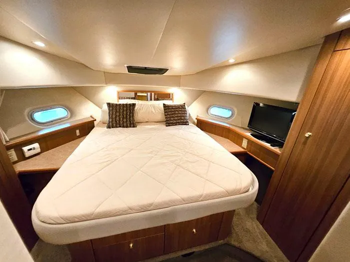 Slide: The Image of Luxurious bedroom in 2000 Bayliner 5288 Pilot House Motoryacht with cozy bed and ambient lighting. - 21