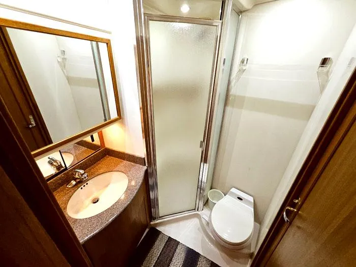 Slide: The Image of Bathroom interior of 2000 Bayliner 5288 Pilot House Motoryacht with shower, sink, and toilet. - 22