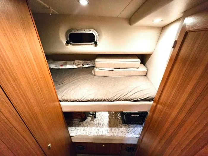 Slide: The Image of Cozy cabin interior of 2000 Bayliner 5288 Pilot House Motoryacht with wooden finishes. - 25