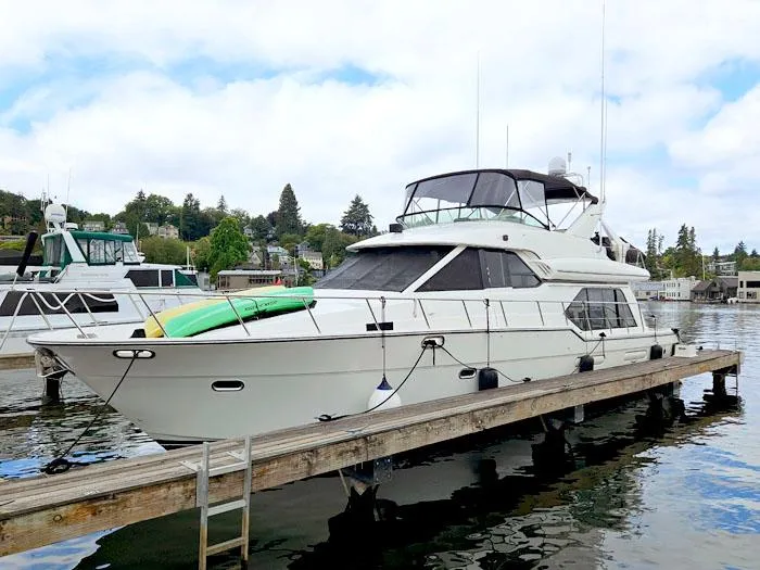 Slide: The Image of 2000 Bayliner 5288 Pilot House Motoryacht docked at a marina, with clear skies. - 3