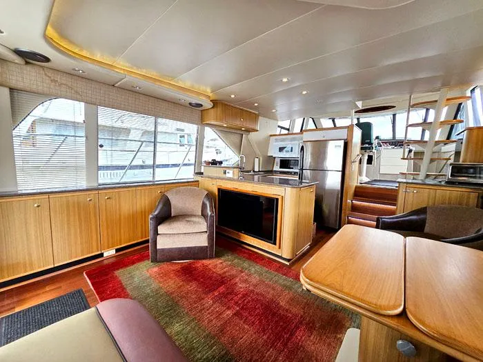 Slide: The Image of Luxurious interior of 2000 Bayliner 5288 Pilot House Motoryacht with modern kitchen and seating area. - 7