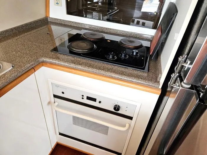 Slide: The Image of Compact kitchen area in a 2000 Bayliner 5288 Pilot House Motoryacht with stove and oven. - 9