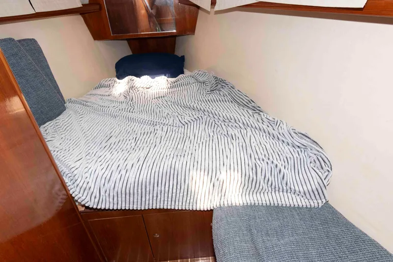 Slide: The Image of Cozy cabin bed in 2006 Hunter 44 Deck Salon yacht with striped bedding. - 15