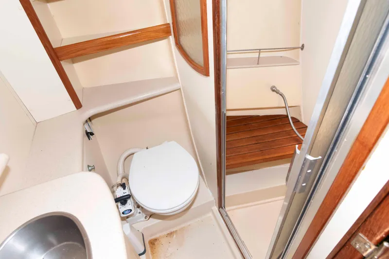 Slide: The Image of Compact bathroom in 2006 Hunter 44 Deck Salon yacht with shower and toilet. - 16