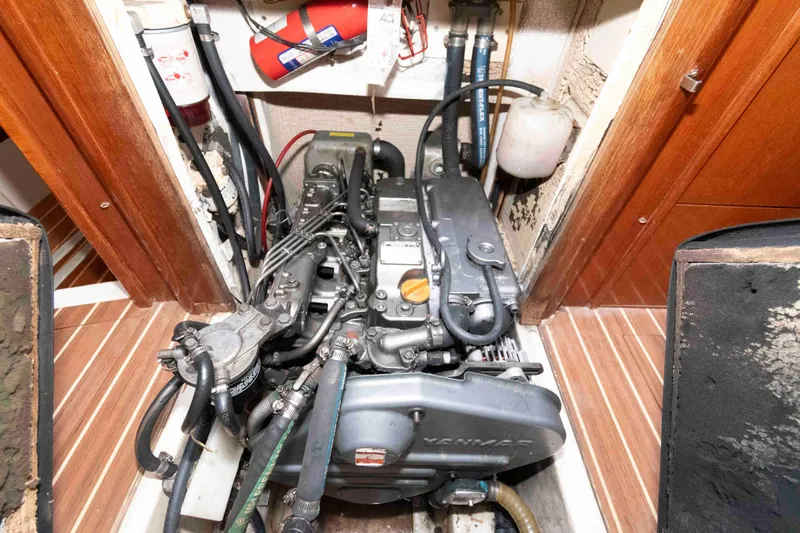 Slide: The Image of Engine compartment of 2006 Hunter 44 Deck Salon sailboat, featuring Yanmar engine and equipment. - 17