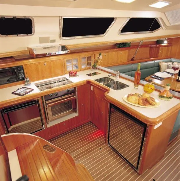 Slide: The Image of 2006 Hunter 44 Deck Salon sailboat on land, showing deck and rigging details. - 3