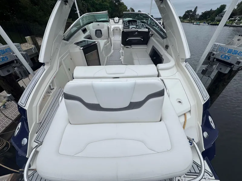 Slide: The Image of 2013 Monterey 328 Super Sport boat interior with white seating and control panel. - 10