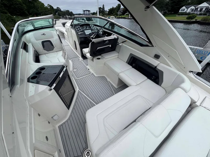 Slide: The Image of 2013 Monterey 328 Super Sport boat interior with luxurious seating and modern dashboard. - 12