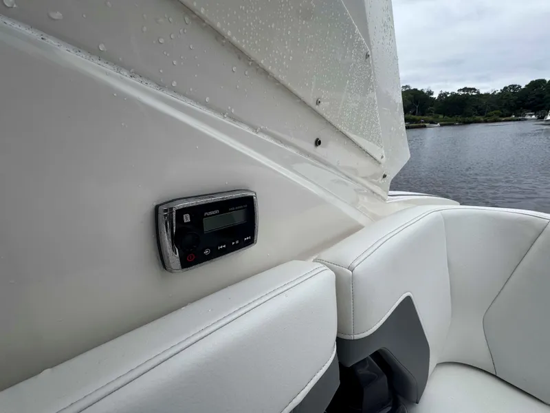 Slide: The Image of Interior of 2013 Monterey 328 Super Sport boat with audio system and white seating. - 19
